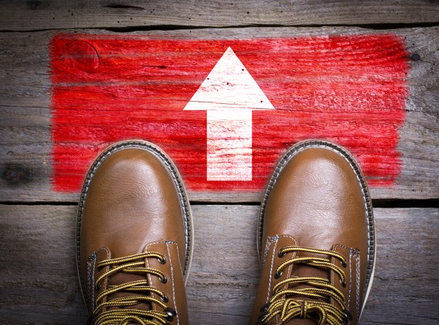 Direction Arrow. Top View of Boot on wooden background